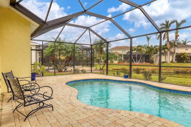 view of swimming pool with a lanai and a patio area