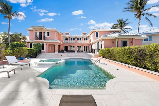 view of pool with a pool with connected hot tub and a patio