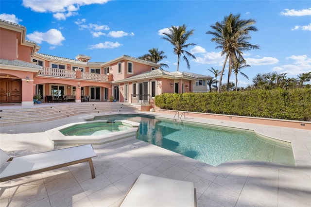 view of pool featuring a pool with connected hot tub and a patio