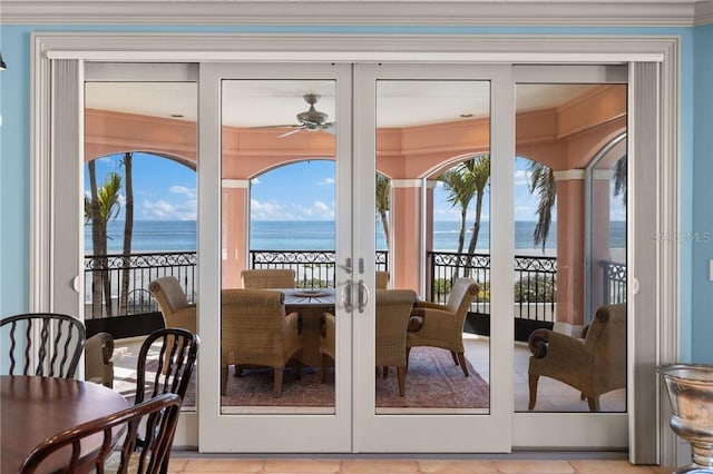 doorway to outside featuring a water view, plenty of natural light, a ceiling fan, and french doors