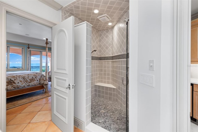 ensuite bathroom featuring a stall shower, tile patterned flooring, connected bathroom, and vanity