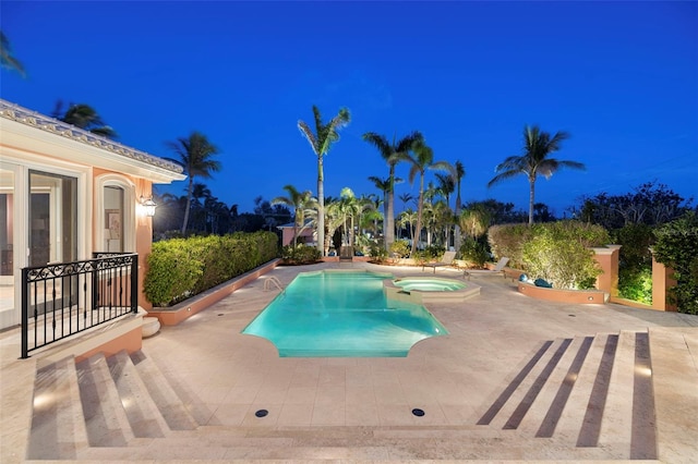 view of pool with a pool with connected hot tub and a patio area