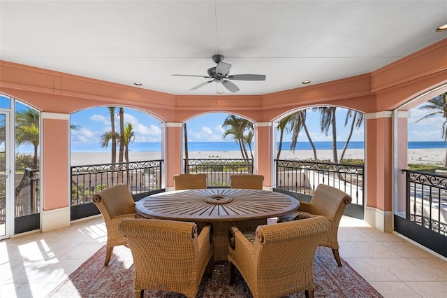 interior space with a water view and a ceiling fan