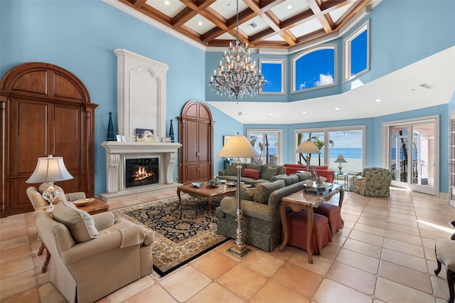 tiled living area featuring a high ceiling, a premium fireplace, a chandelier, and coffered ceiling