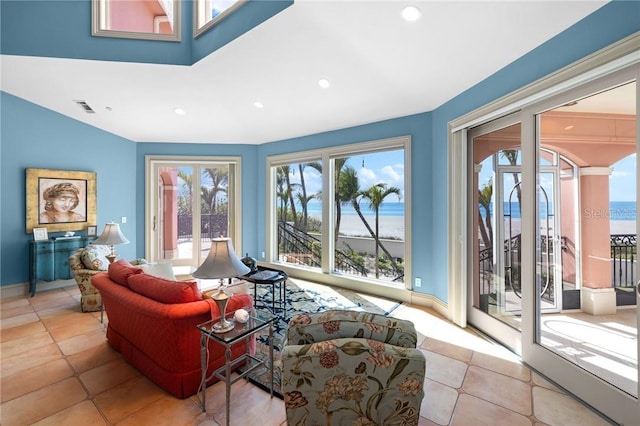 tiled living room with recessed lighting, visible vents, and baseboards