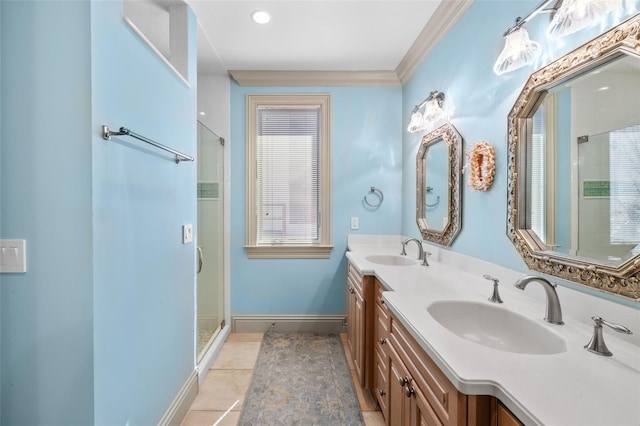 full bath featuring a stall shower, baseboards, a sink, and tile patterned floors