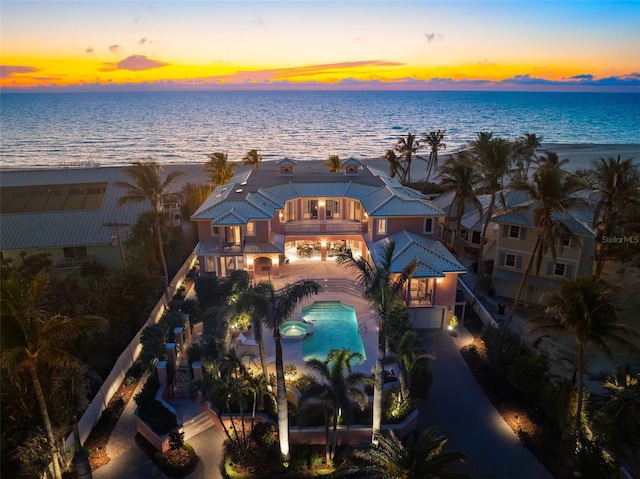 aerial view at dusk with a water view