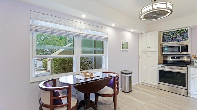 dining area featuring light wood-type flooring