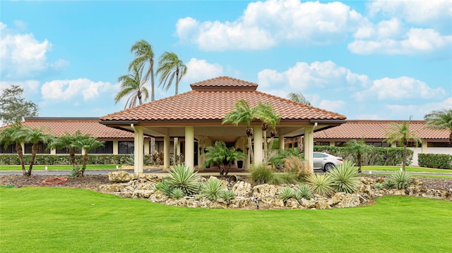 exterior space featuring a tile roof and a lawn