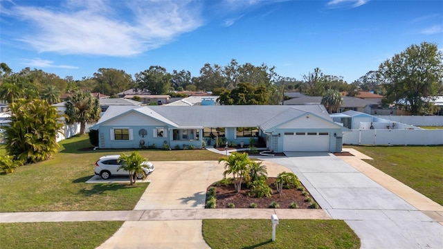 single story home with a garage and a front lawn