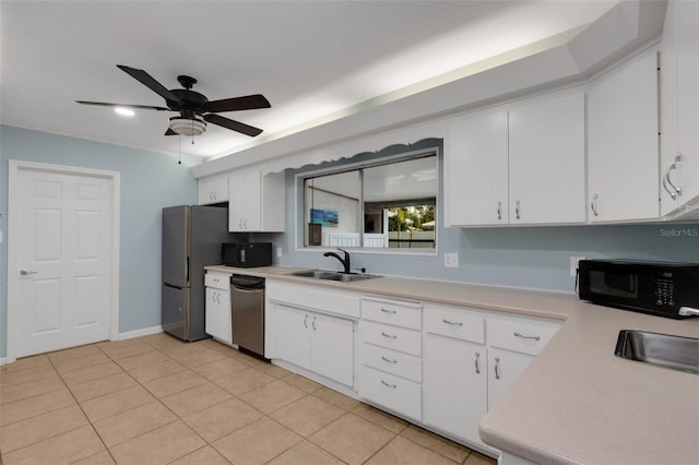 kitchen featuring sink, ceiling fan, appliances with stainless steel finishes, white cabinetry, and light tile patterned flooring