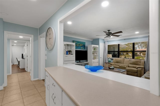 kitchen featuring light tile patterned floors, white cabinets, and ceiling fan