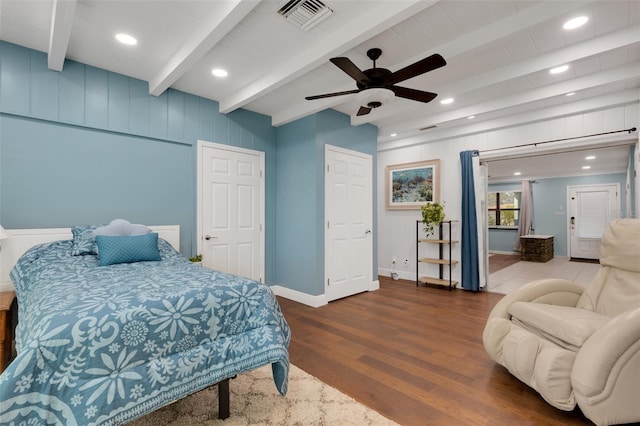 bedroom with hardwood / wood-style floors, beamed ceiling, and ceiling fan