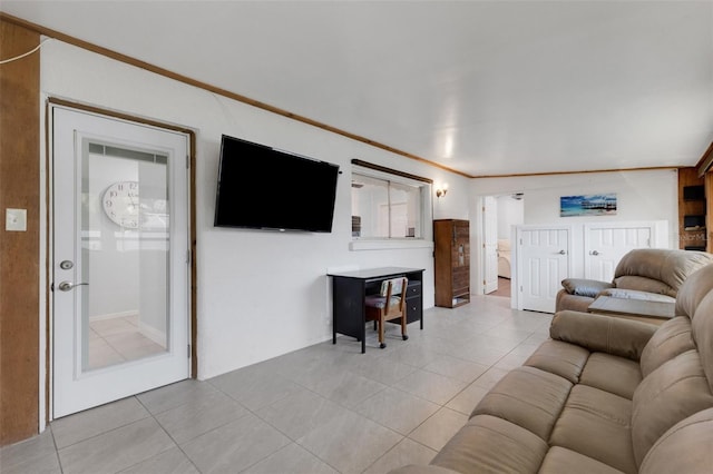 living room featuring light tile patterned flooring and crown molding