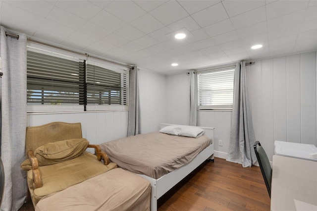 bedroom with dark hardwood / wood-style flooring