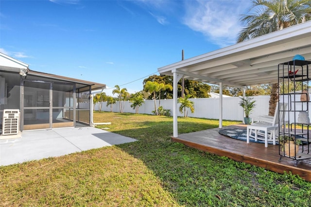 view of yard featuring a sunroom and a deck