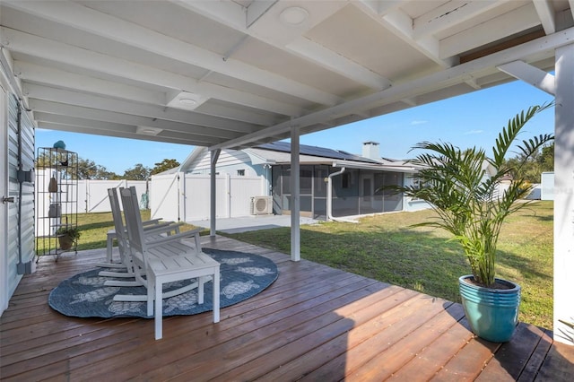 wooden terrace featuring ac unit, a lawn, and a sunroom