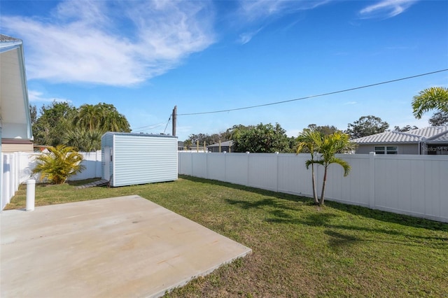 view of yard with a storage shed and a patio