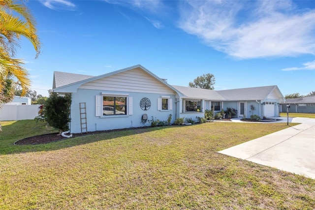 ranch-style home featuring a garage and a front yard