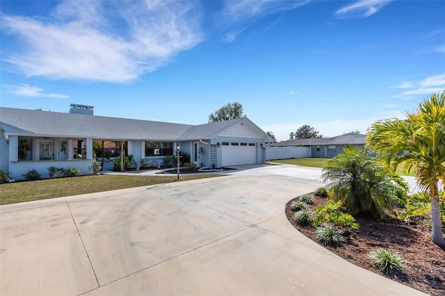 single story home with a garage and a front lawn