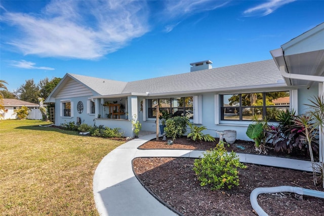 ranch-style home with a front lawn