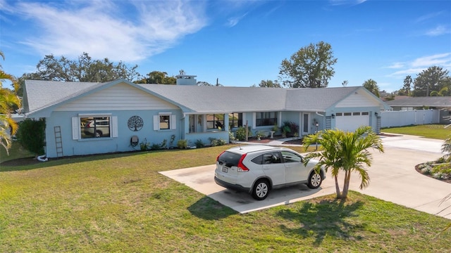 single story home with a garage and a front lawn