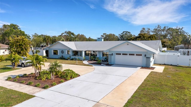 ranch-style home featuring a garage and a front lawn