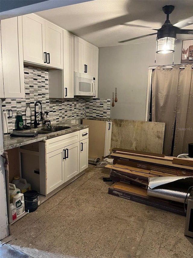 kitchen with white cabinets and decorative backsplash