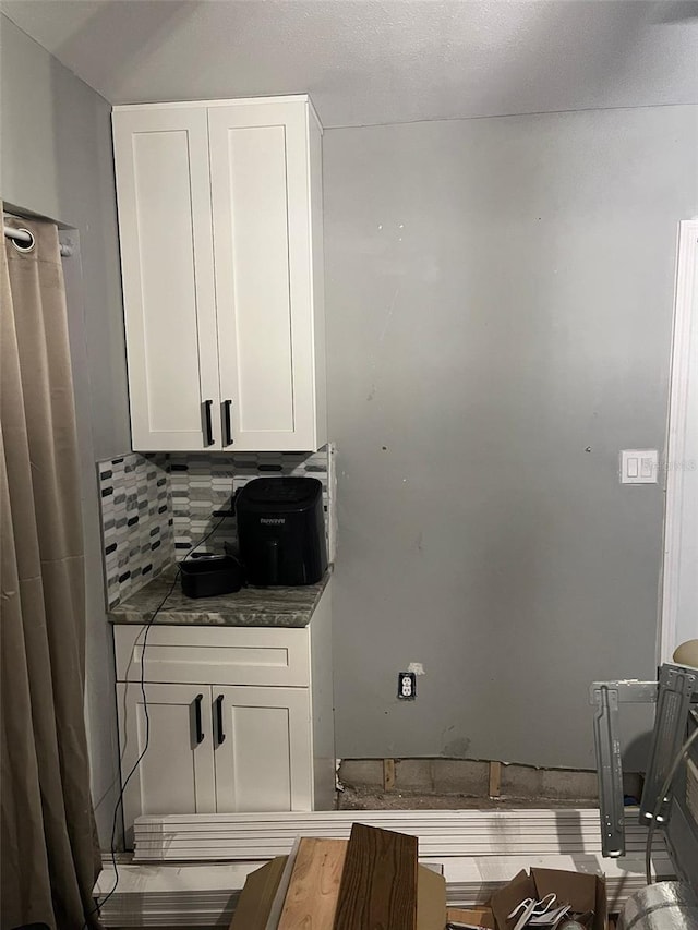 kitchen with white cabinetry and decorative backsplash