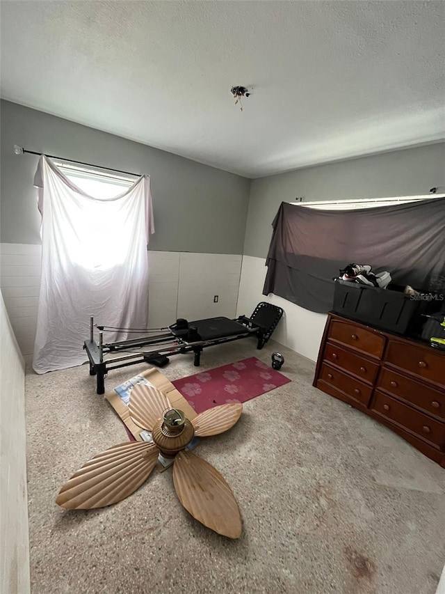 bedroom with light carpet and a textured ceiling