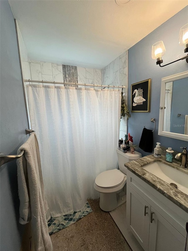 bathroom featuring vanity, toilet, and a shower with curtain