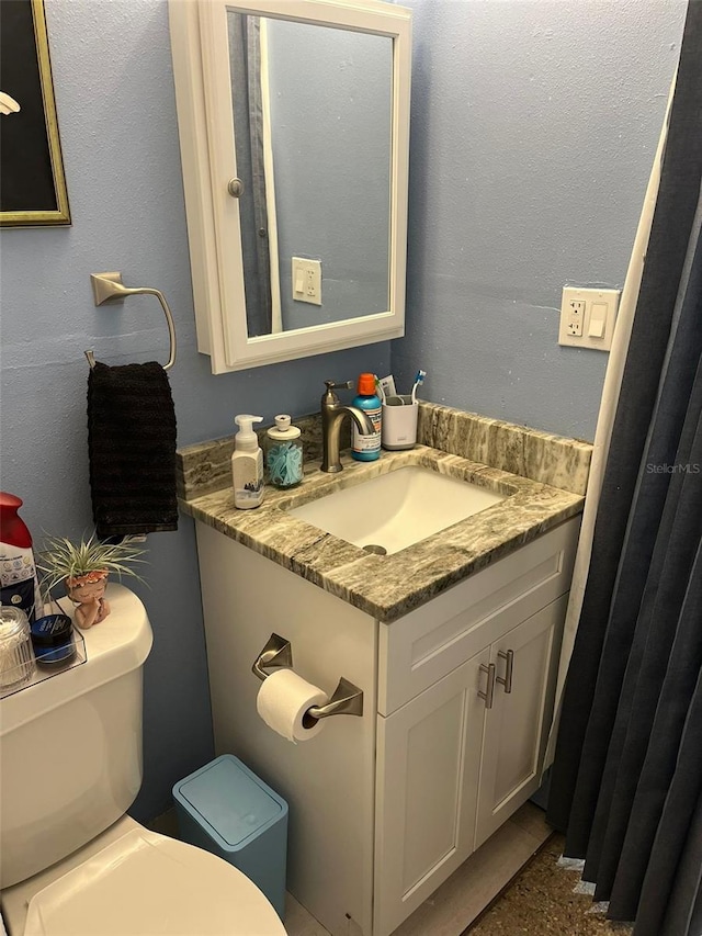 bathroom featuring vanity and toilet