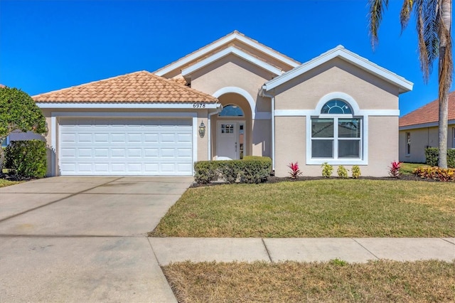 single story home featuring a garage and a front yard