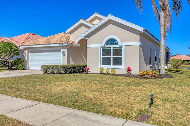 view of front of property featuring a garage and a front yard