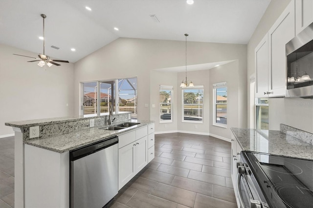 kitchen featuring pendant lighting, sink, appliances with stainless steel finishes, a kitchen island with sink, and white cabinets