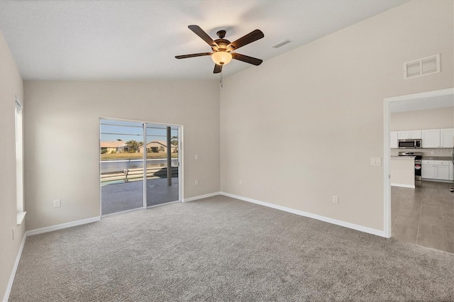 unfurnished room with lofted ceiling, carpet floors, and ceiling fan