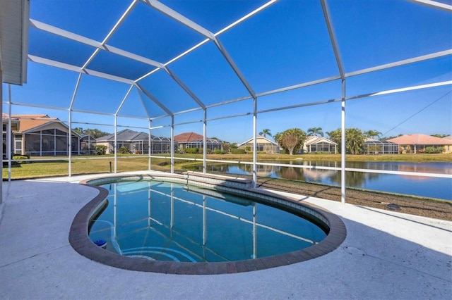 view of swimming pool with a patio, a yard, a water view, and glass enclosure