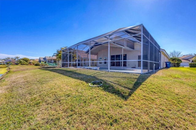 rear view of house with a yard, a lanai, and a patio area