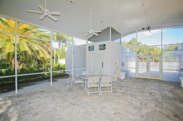 unfurnished sunroom with ceiling fan