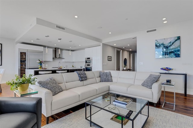 living room featuring sink and light hardwood / wood-style floors