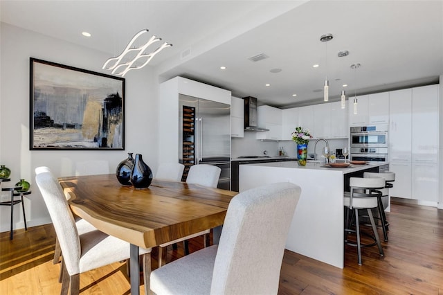 dining space with dark hardwood / wood-style floors and sink