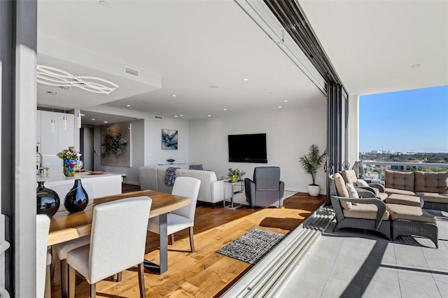 dining space with hardwood / wood-style floors and expansive windows