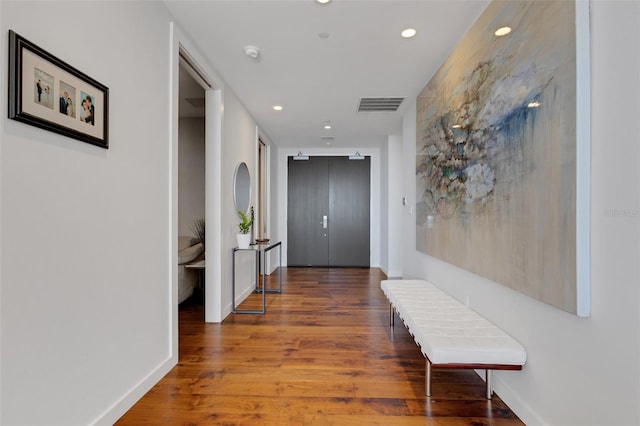 hallway featuring hardwood / wood-style flooring and elevator