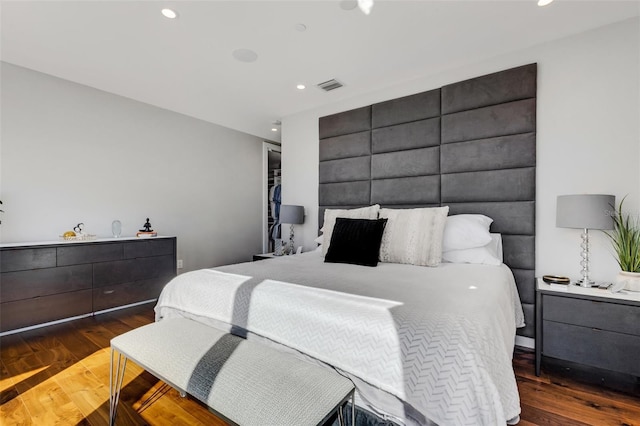 bedroom with dark hardwood / wood-style flooring