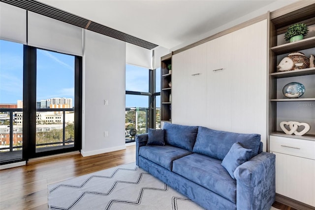 living room featuring hardwood / wood-style floors and built in features