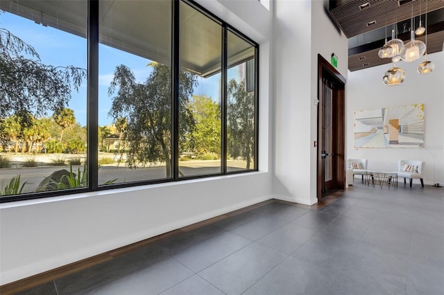 unfurnished sunroom featuring an inviting chandelier