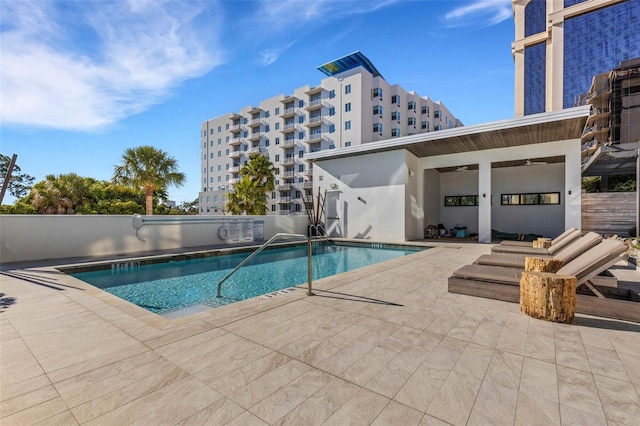 view of pool with ceiling fan and a patio area