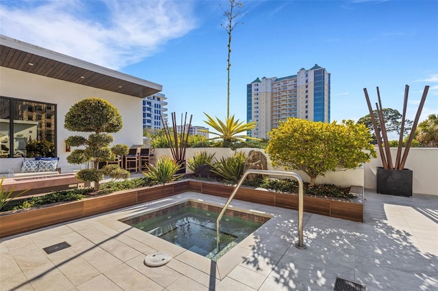 view of pool featuring a hot tub and a patio area