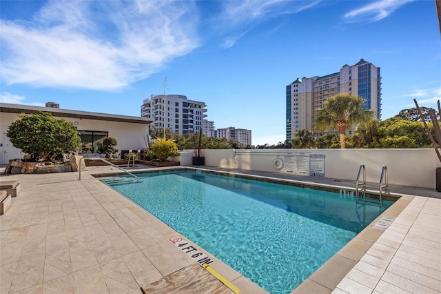 view of swimming pool with a patio