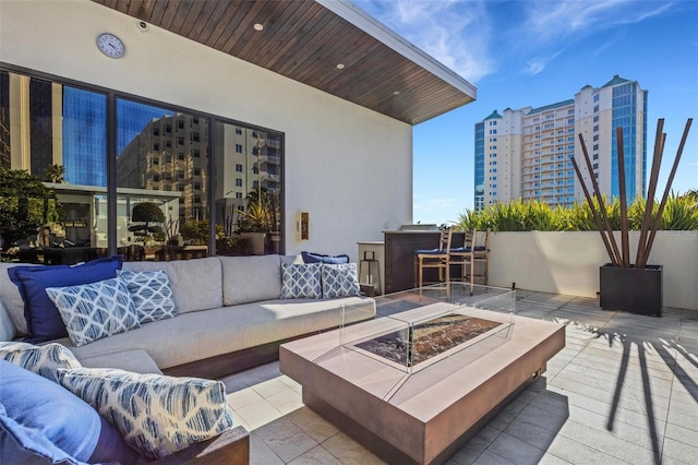 view of patio featuring an outdoor living space with a fire pit